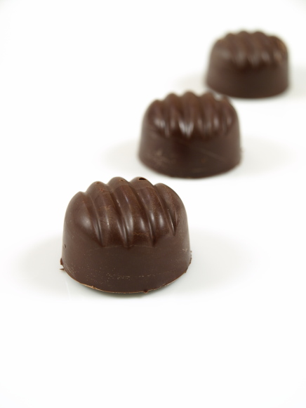 Molded 72% cacao chocolates filled with rosewater almond praline Photo of molded 72% cacao chocolates filled with rosewater almond praline